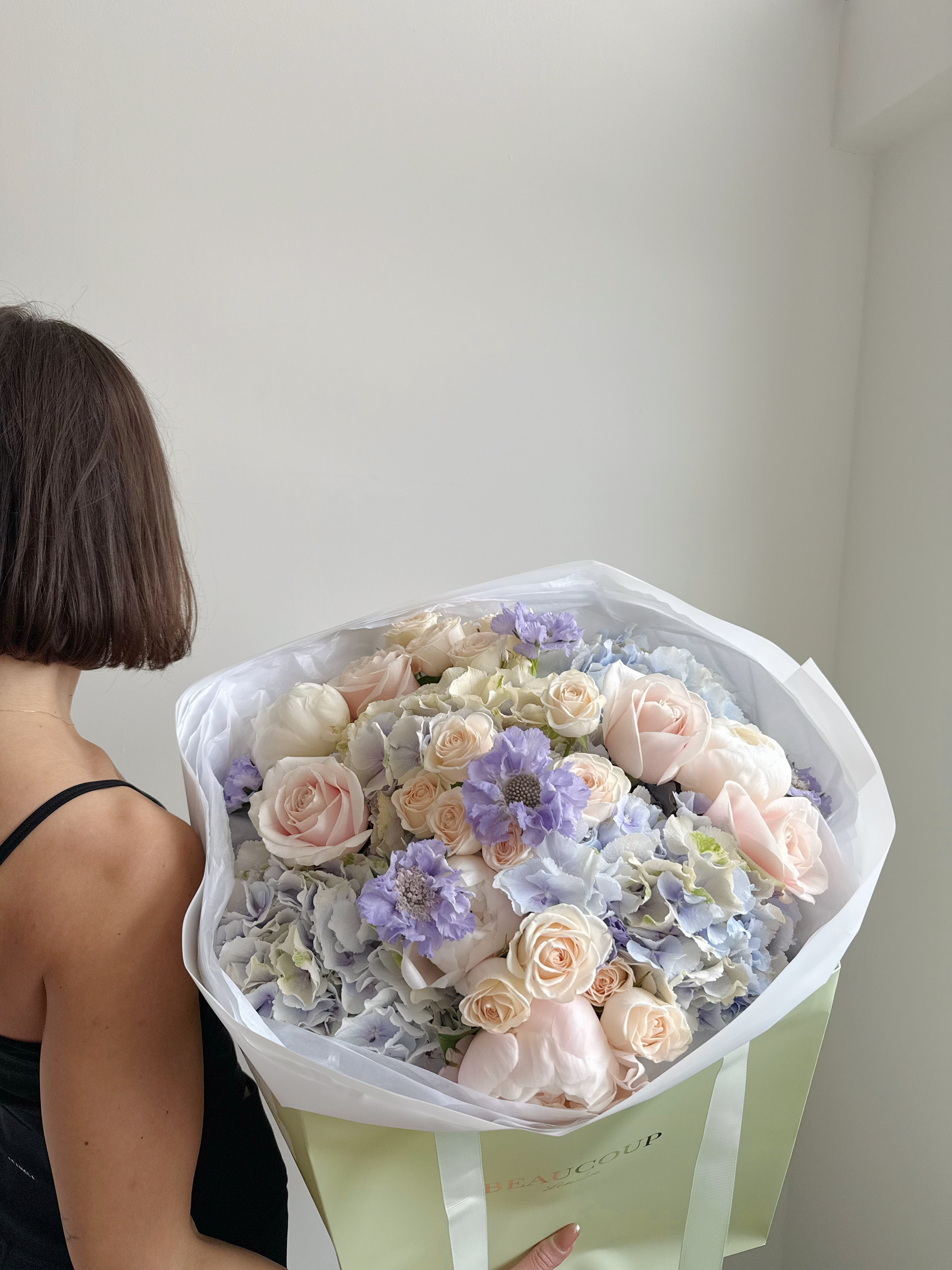 Florist choice blue bouquet with cream and pale pink flowers delivered in London